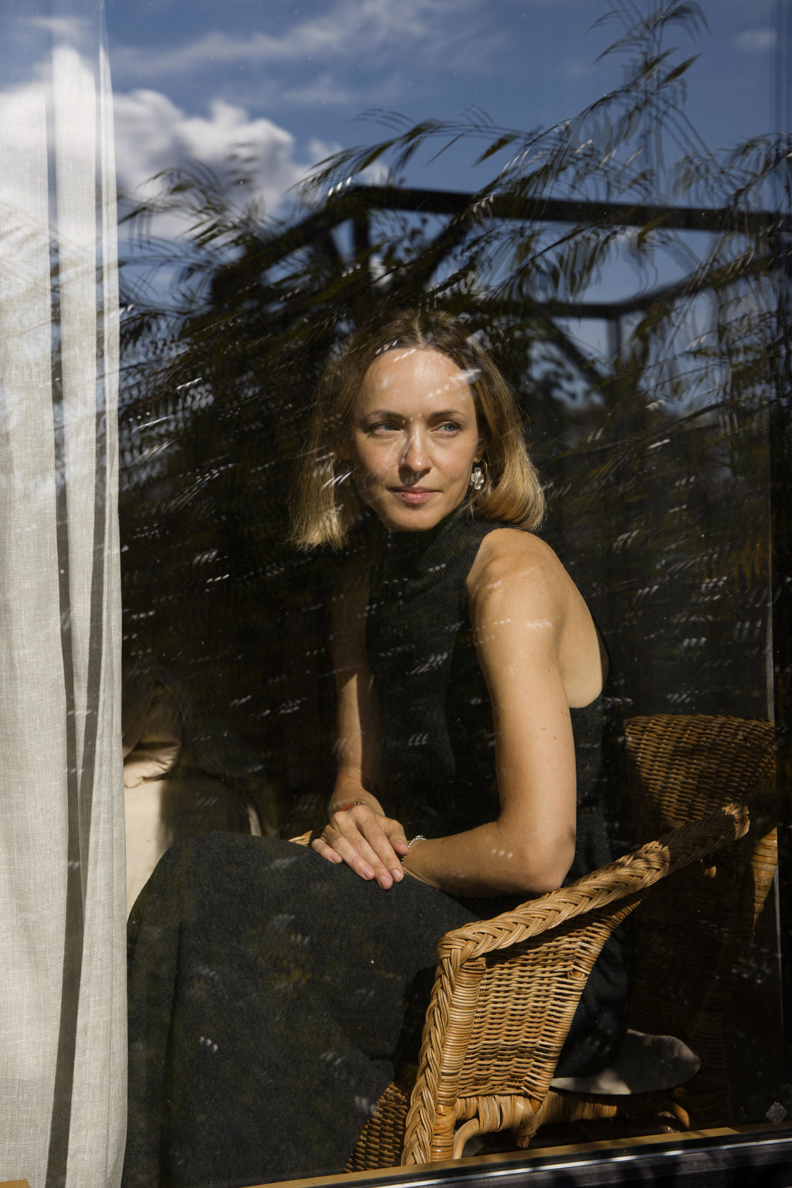 A woman in a lived-in interior, mid-thought